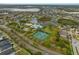Community aerial view showcasing a pool, tennis courts, and lush green spaces at 11818 Gilmerton Dr, Riverview, FL 33579