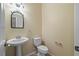 Clean bathroom featuring a pedestal sink, toilet, mirror, and towel rack at 11818 Gilmerton Dr, Riverview, FL 33579
