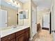 Hall bathroom with double sinks, cabinet, mirror, and tiled floors at 11818 Gilmerton Dr, Riverview, FL 33579