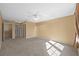 Neutral bedroom with carpeting, ceiling fan, and multiple windows, and hallway doors at 11818 Gilmerton Dr, Riverview, FL 33579
