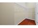 Walk-in closet with hardwood floors, shelving, and a door at 11818 Gilmerton Dr, Riverview, FL 33579