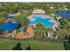 Aerial view of a community pool and a playground, perfect for Gathering fun at 11818 Gilmerton Dr, Riverview, FL 33579