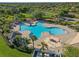 Aerial view of a community pool with a splash pad and lounging area for Gathering enjoyment at 11818 Gilmerton Dr, Riverview, FL 33579