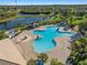Aerial view of a large community pool with nearby lounging areas and tropical landscaping at 11818 Gilmerton Dr, Riverview, FL 33579