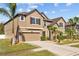 Charming home featuring manicured landscaping, a two-car garage, and a welcoming driveway at 11818 Gilmerton Dr, Riverview, FL 33579
