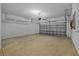 Clean, well-lit garage features epoxy flooring, overhead storage, and a modern garage door opener at 11818 Gilmerton Dr, Riverview, FL 33579