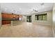 Expansive living space with a kitchen featuring a central island, ample counter space, and abundant cabinetry at 11818 Gilmerton Dr, Riverview, FL 33579