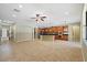 Spacious open-plan living and dining area features a kitchen with island, bright tiles, and lots of open space at 11818 Gilmerton Dr, Riverview, FL 33579