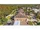 Rear view of the home featuring a screened pool, fenced yard, and lush tropical landscaping at 11818 Gilmerton Dr, Riverview, FL 33579