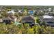 Aerial showcasing the backyard, screened pool, lush landscaping, and surrounding neighborhood at 11818 Gilmerton Dr, Riverview, FL 33579