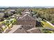 Rear exterior showing a screened-in patio, large yard, and well-kept landscaping around the property at 11818 Gilmerton Dr, Riverview, FL 33579