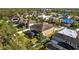 Overhead perspective of the home's exterior, featuring a screened-in pool, private yard, and mature trees at 11818 Gilmerton Dr, Riverview, FL 33579