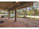 Covered screened patio with brick flooring, ceiling fan, and an outdoor view at 11818 Gilmerton Dr, Riverview, FL 33579