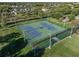 Aerial view of tennis courts surrounded by lush greenery, providing an active lifestyle at 11818 Gilmerton Dr, Riverview, FL 33579