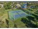 Aerial view of tennis courts near a community pool and other recreational amenities at 11818 Gilmerton Dr, Riverview, FL 33579
