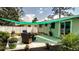 Cozy back patio with outdoor seating area and shaded awning, perfect for relaxing or entertaining guests at 70 Virginia Ct, Englewood, FL 34223