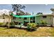 Landscaped backyard with a charming patio seating area, ideal for enjoying outdoor living at 70 Virginia Ct, Englewood, FL 34223