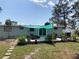 Backyard featuring refreshed landscaping, outdoor seating, stone pathway, and shade covering at 70 Virginia Ct, Englewood, FL 34223
