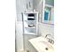 Bathroom featuring a corner cabinet with open shelves for towel storage and a white sink at 70 Virginia Ct, Englewood, FL 34223