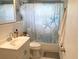 Bright bathroom featuring a white vanity, coastal decor, and a shower with a starfish-themed curtain at 70 Virginia Ct, Englewood, FL 34223