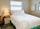 Bright bedroom featuring a comfortable bed, and a large window offering ample natural light at 70 Virginia Ct, Englewood, FL 34223