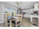 Open dining area connected to a modern kitchen with stainless steel appliances and bright windows at 70 Virginia Ct, Englewood, FL 34223