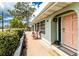 Charming home featuring a lovely, covered front porch with comfortable seating and an inviting coral-colored door at 70 Virginia Ct, Englewood, FL 34223