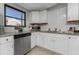 Updated kitchen boasts stainless appliances, white cabinets, and granite countertops at 70 Virginia Ct, Englewood, FL 34223