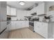 Updated kitchen features stainless steel appliances, white cabinets, and a subway tile backsplash at 70 Virginia Ct, Englewood, FL 34223