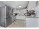 Modern kitchen featuring stainless steel appliances, white cabinets, and a subway tile backsplash at 70 Virginia Ct, Englewood, FL 34223