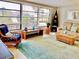 Bright living room with large windows and wicker furniture at 70 Virginia Ct, Englewood, FL 34223