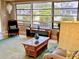 Bright living room with large windows, a comfortable seating arrangement, and stylish decor at 70 Virginia Ct, Englewood, FL 34223