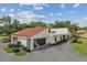 Home exterior featuring well-maintained landscaping, two-car garage, and American flag display at 107 Seville N Ct, Plant City, FL 33566
