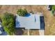 Aerial view of house with grey roof and surrounding trees at 22131 Bahama Ave, Port Charlotte, FL 33952