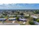 Wide aerial view of a neighborhood featuring charming single-story homes with well-maintained lawns and mature trees at 22131 Bahama Ave, Port Charlotte, FL 33952