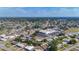 High angle view of a neighborhood with cozy homes, a waterway, a community center, and a network of roads amid mature trees at 22131 Bahama Ave, Port Charlotte, FL 33952