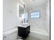 This bathroom has a modern sink, marbled walls, and shower at 22131 Bahama Ave, Port Charlotte, FL 33952