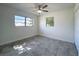 Bedroom featuring tile floor, a ceiling fan, and two windows at 22131 Bahama Ave, Port Charlotte, FL 33952