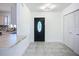 Spacious entryway with a decorative front door, closet, and a view into the kitchen area at 22131 Bahama Ave, Port Charlotte, FL 33952
