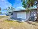 Back of home with grey paint and a large grass area at 22131 Bahama Ave, Port Charlotte, FL 33952