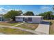 Low aerial view of this single-story residence shows a concrete driveway and neat front yard landscaping at 22131 Bahama Ave, Port Charlotte, FL 33952