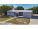 Attractive single-story home with a screened front entry, red shutters, and a fresh white roof at 22131 Bahama Ave, Port Charlotte, FL 33952