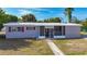 Inviting single-story home showcasing a screened entryway, classic shutters, and tidy landscaping at 22131 Bahama Ave, Port Charlotte, FL 33952
