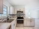 Updated kitchen with stainless appliances, modern cabinets, and backsplash at 22131 Bahama Ave, Port Charlotte, FL 33952