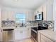 Updated kitchen featuring stainless steel appliances and modern backsplash at 22131 Bahama Ave, Port Charlotte, FL 33952