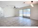 Open concept living room with tile floors and backyard access at 22131 Bahama Ave, Port Charlotte, FL 33952