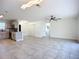 Open living room with tile flooring, ceiling fan, and neutral paint at 22131 Bahama Ave, Port Charlotte, FL 33952