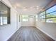 Bright living room featuring hardwood floors and multiple windows at 22131 Bahama Ave, Port Charlotte, FL 33952