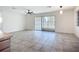 Open concept living room with tile floors and backyard access at 22131 Bahama Ave, Port Charlotte, FL 33952