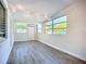 Bright living room featuring hardwood floors and multiple windows at 22131 Bahama Ave, Port Charlotte, FL 33952